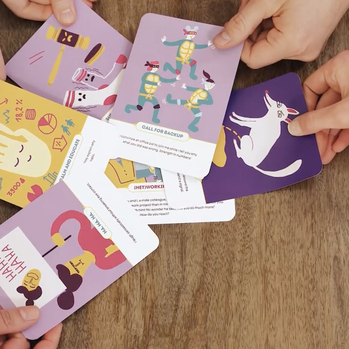 Hands arranging EQT cards together on a table